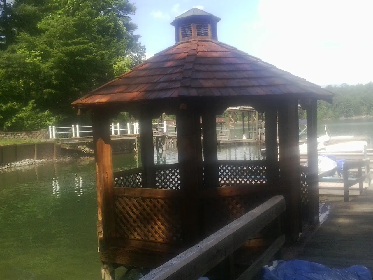 Cedar shake gazebo roof rebuilt on a lake dock in Moody